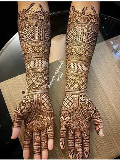 A beautiful and clean example of full hand bridal mehandi. The geometric patterns combined with floral elements give it a very rich and textured appearance, perfect for the modern bride.