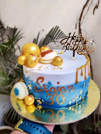 Happy 30th Birthday! This blue ombre cake with gold drip and golden chocolate spheres is a stylish way to celebrate a big milestone.