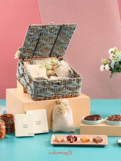 An open view of the grey jute hamper, filled with gourmet snacks and treats. The natural texture of the jute combined with elegant contents creates a wonderful contrast.
