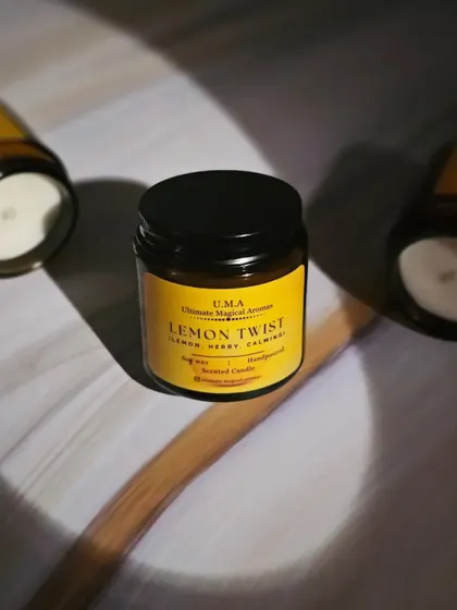 A 'Lemon Twist' candle in its amber jar, perfect for creating a serene ambiance that helps you unwind after a long day.