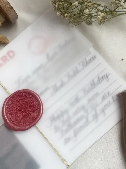 Everything old-school. This custom postcard features a handwritten birthday message and a quote from Shah Rukh Khan, wrapped in vellum and sealed with a red wax stamp for a vintage feel.