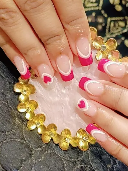 A playful and romantic design with bright pink French tips, white line details, and cute heart accents on square nails.