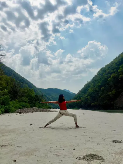 Opening up in Virabhadrasana II, the warrior two pose, with the majestic Himalayas as my backdrop. This pose builds strength and stability, reflecting the mountains around us.