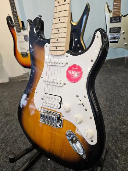 A close-up on the body of the Fender FSR Stratocaster HSS. You can see the detail of the bridge, the HSS pickup layout, and the volume and tone knobs, all essential components of its versatile sound.