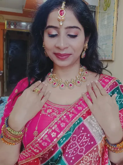 A close-up of the client's festive look, highlighting the beautiful jewellery and the vibrant colors of the dupatta.