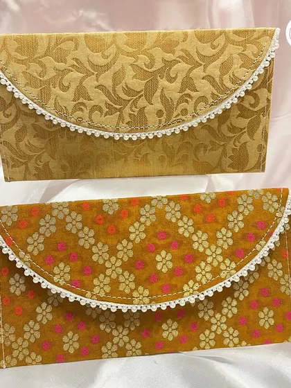 A pair of custom wedding envelopes in different traditional patterns. These can be used for invitations or as shagun envelopes.