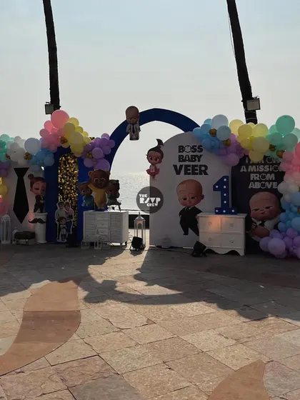 A wide shot of the Boss Baby setup, showing the full backdrop and decor against the ocean view.