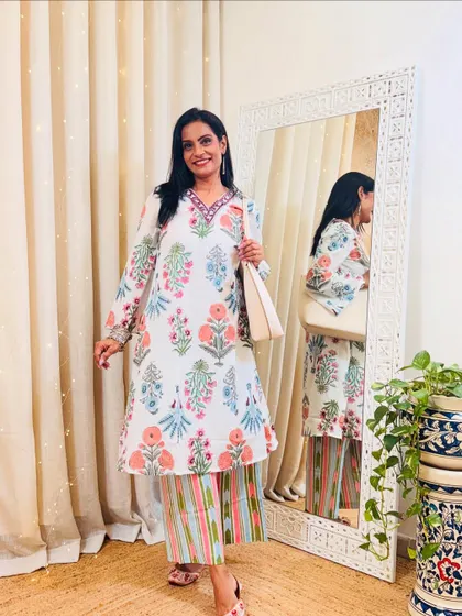 This white floral printed kurta with striped pants is a beautiful and fresh combination. It's a perfect summer workwear outfit.