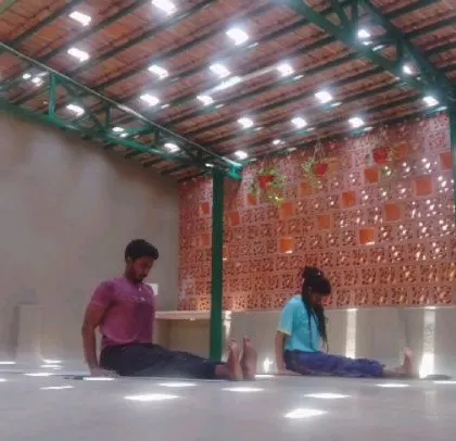 Practicing Dandasana (Staff Pose) in our beautiful rooftop studio. The light filtering through the ceiling creates a magical atmosphere for our Ashtanga Vinyasa and Pranayama classes.