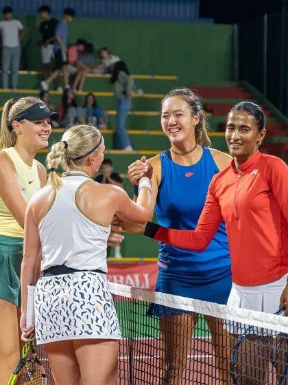 Sharing a handshake at the net, a sign of respect and sportsmanship after a competitive doubles match.