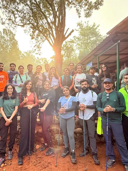 The team is all smiles at the start of the Kumara Parvatha trek. We provide trekking poles and guidance to make sure everyone is prepared for the journey ahead.