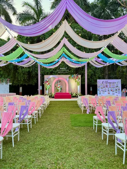 A wide view of the lawn, showing the full extent of the pastel draping and seating arrangement.