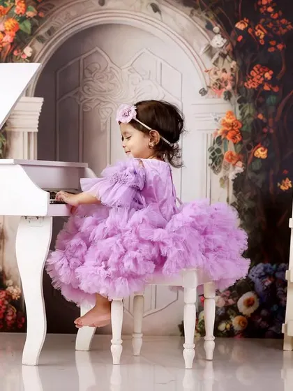 A little princess at her piano. This lavender tutu dress and floral backdrop create a whimsical and elegant portrait for her milestone session.