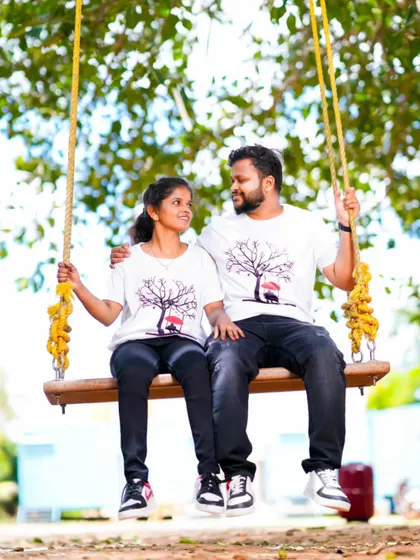 A sweet moment shared on a swing, with the couple wearing matching t-shirts. This is a great example of a relaxed and natural pre-wedding photo.