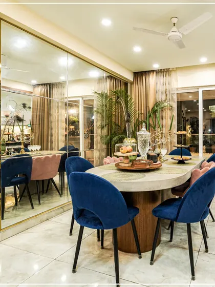 The dining room is where memories are made. For this space, I chose bold, jewel-toned velvet chairs and a large mirrored wall to create an atmosphere of modern luxury. It’s a design that feels both glamorous and welcoming, perfect for everything from daily meals to festive gatherings.
