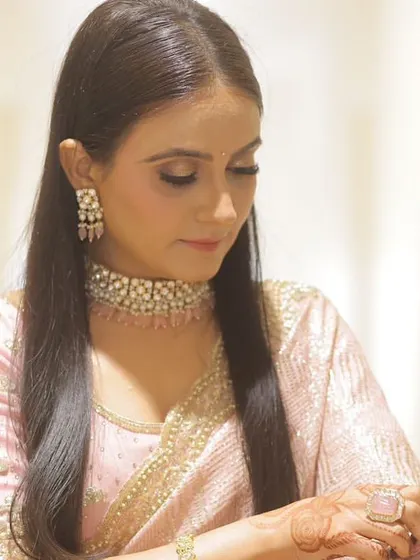 A close up of the engagement bride, showing the soft, shimmery eye makeup and the delicate jewelry.