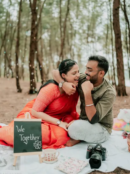 A happy, candid moment between a couple during their picnic-themed pre-wedding shoot.