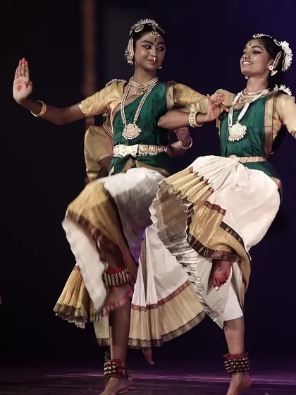Two dancers in a synchronized leap, a testament to their skill and practice.