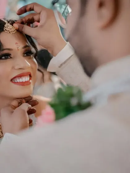 A close-up of a tender moment during the wedding ceremony, filled with smiles and genuine emotion.