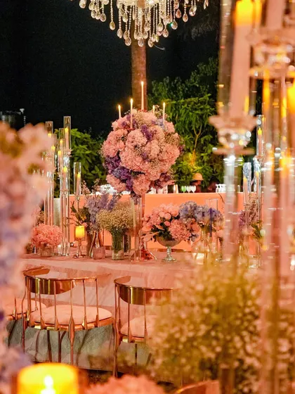 A view of the fairytale-themed dinner setup, with large floral centerpieces and crystal candelabras creating a luxurious and magical ambiance. The soft pink and blue color palette is both romantic and sophisticated.