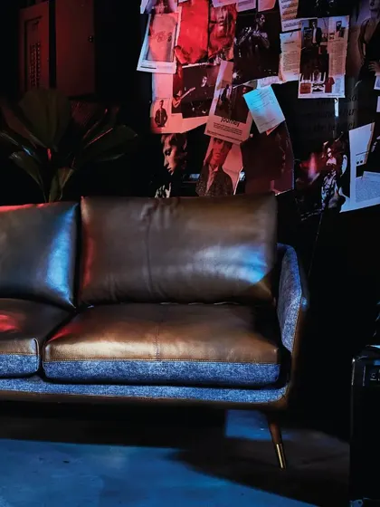The Volta Sofa in a classic two-seater configuration. The rich leather and fabric combination, paired with an edgy, industrial-inspired setting, showcases the versatility and bold character of this collection.