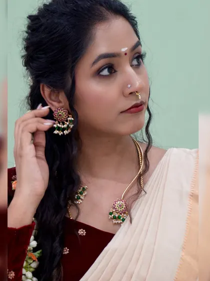 A side profile from the Onam look, showcasing the jewelry and the intricate hairstyle.