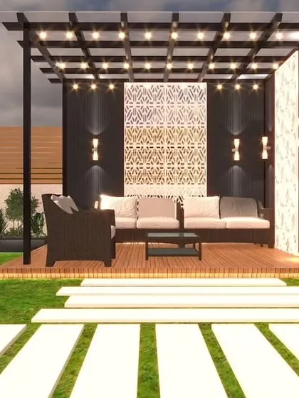 A pergola design with a decorative back panel. The comfortable seating and modern lighting make it an inviting outdoor lounge area.
