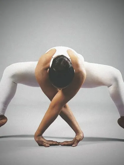 A closer look at the Goddess Pose variation, highlighting the deep squat and arm bind. This pose strengthens the legs while creating significant space in the hips and shoulders.