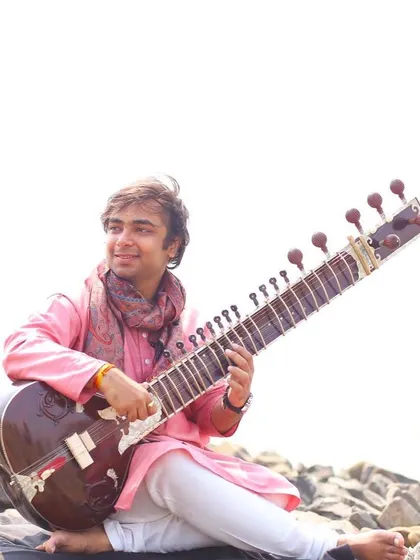 An outdoor photoshoot. I believe the sitar, a natural wooden instrument, looks beautiful in nature.