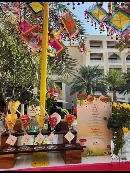 This vibrant Mehendi bar setup features colorful kite decorations and fruit-garnished cocktails. It's a perfect example of how we incorporate cultural and festive elements into our bar designs.