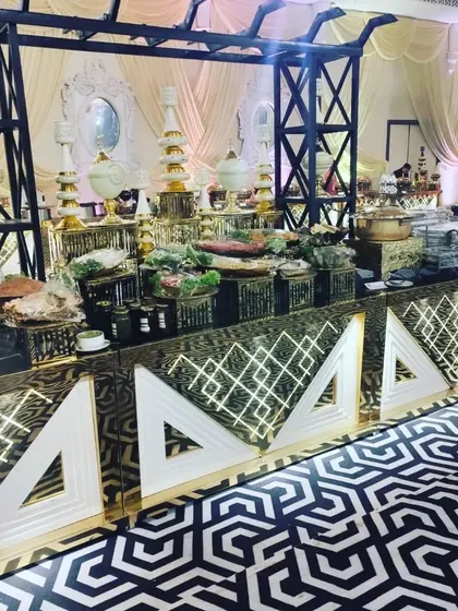 This salad and cold appetizers station is set up on a modern, illuminated counter that contrasts beautifully with the venue's classic decor, making the fresh food a central feature.