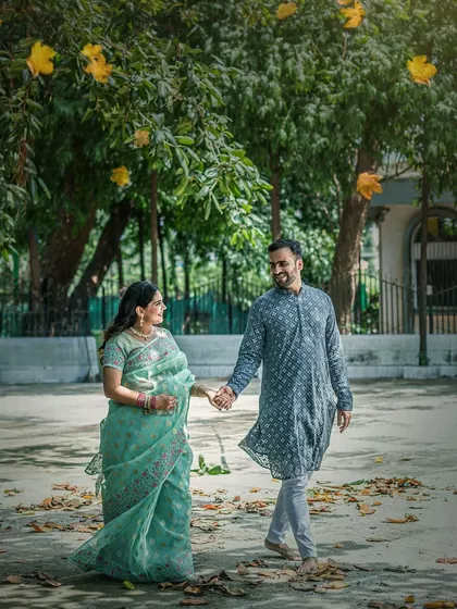A quiet walk under a canopy of trees, with golden leaves falling like blessings. I love capturing these simple, unscripted moments of connection for expecting couples, where nature itself seems to celebrate with you.