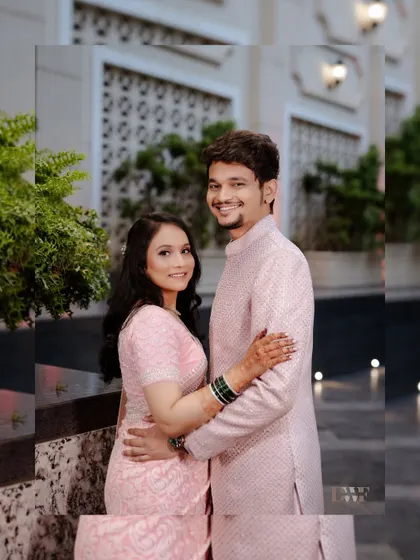 A classic portrait of the engaged couple. Their happy smiles and comfortable embrace show their deep affection for one another.