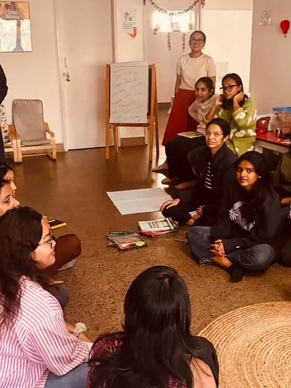 Our training sessions are collaborative circles, not lectures. Here, a parent leads an inspiring session on experiential learning, sharing her expertise with our team.