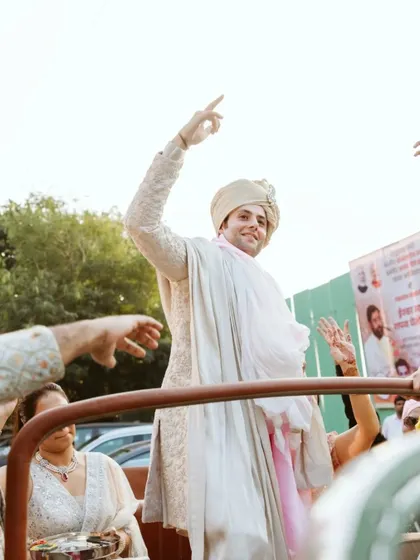 The groom's grand entrance, dancing on a jeep. This shot captures the energy and excitement of the Baraat.