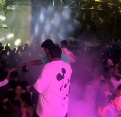 Smoke and purple lights fill the dance floor.