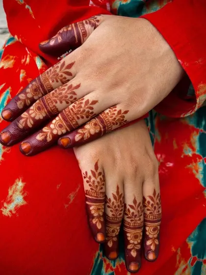 Another example of a beautiful, mature henna stain. The color is deep and even, highlighting the intricate details of the finger designs.
