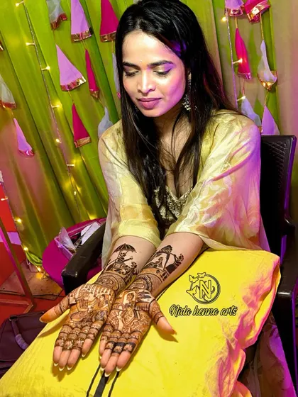 The happy bride with her completed figurative mehandi, a beautiful canvas of her wedding story.