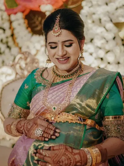A happy, smiling shot of Niharika at her baby shower. The makeup is designed to photograph beautifully, capturing all the joy of this special day.