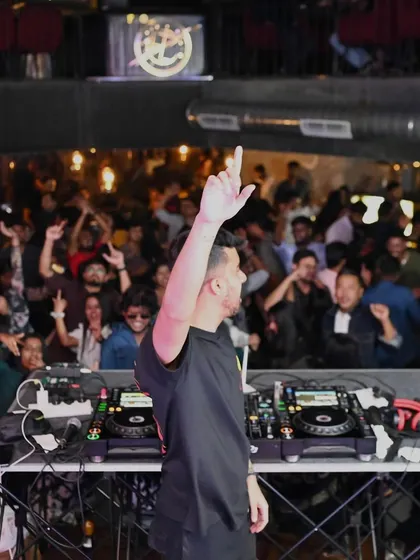 Another angle of me connecting with the crowd, hand raised. It's a signature pose that signals it's time to go wild.