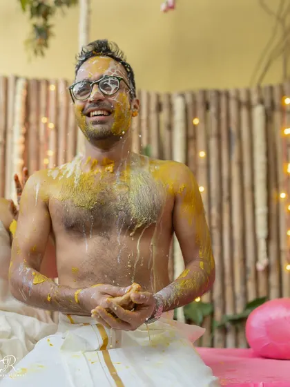 The groom's happy reaction after being covered in haldi and water by his loved ones.