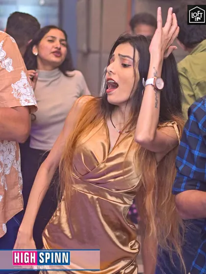 A dancer completely lost in the moment, feeling the golden vibes of the party.