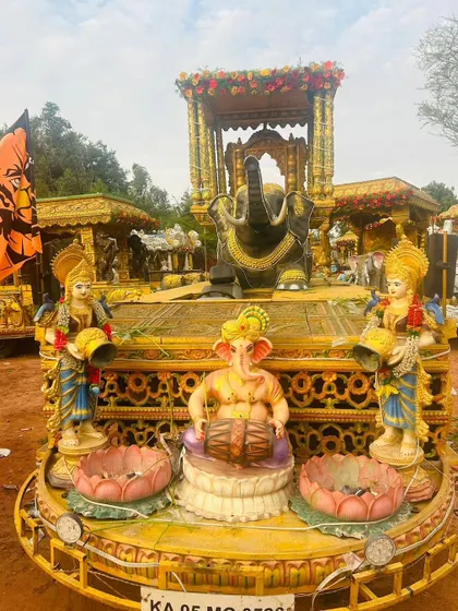 This Ratha Gadi features a seated Ganesha playing a drum, an elephant, and other deities, all part of a grand procession.
