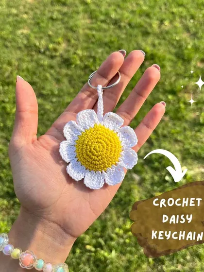A cute crochet daisy keychain, a perfect little gift to brighten someone's day.