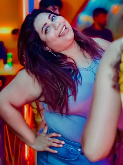 A confident pose and a happy smile from a guest enjoying the vibe.