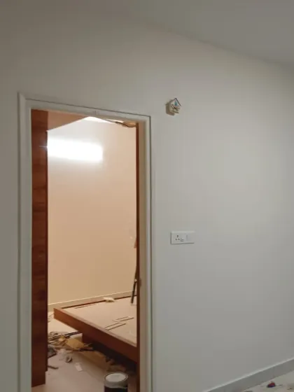 A view from one freshly painted room into another, showing consistent, high-quality work with clean lines around the door frame.