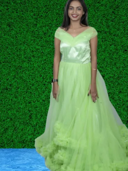 A fresh and vibrant lime green gown with an off-shoulder neckline and a ruffled hem. This is a great choice for a spring or summer photoshoot.