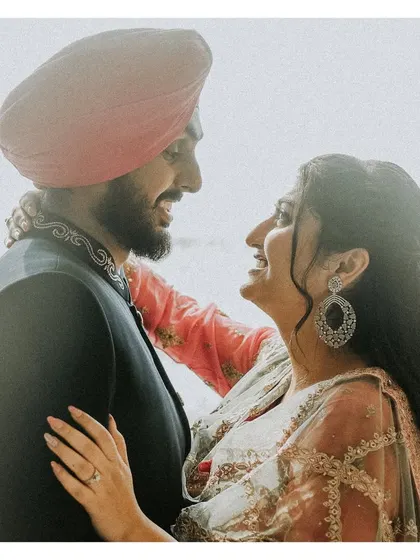 A happy, candid close-up of the couple. Their genuine smiles and the way they look at each other tell a story of love and happiness.