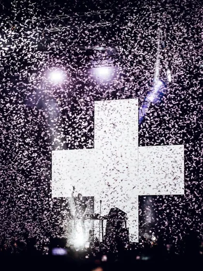 A celebratory shot of Martin Garrix against his iconic cross logo, showered in confetti after being crowned the world's number one DJ.