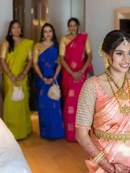 A classic portrait of the bride with her bridesmaids. Everyone looks stunning in their coordinated sarees, a perfect memory of the bride tribe.